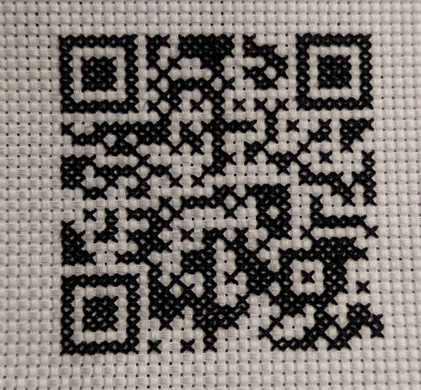 cross-stitch of a QR code that points to www.wondra.codes/qr.html'